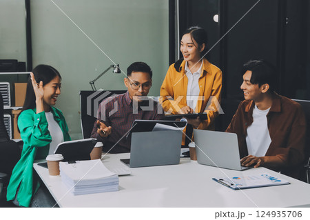 Business team showing unity with their hands together, Close up top view of young business people putting their hands together. people together to work as team to ensure the success of the business 124935706