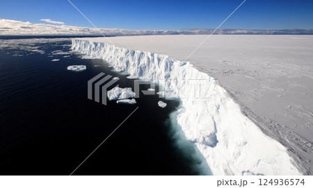 Aerial view of melting polar ice sheet against clear blue sky 124936574