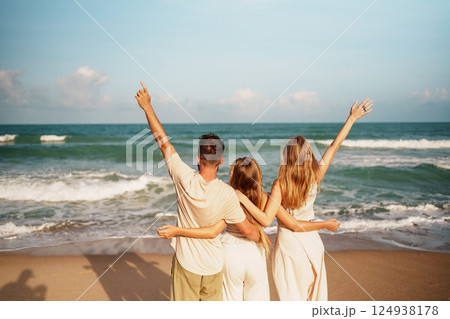 Joyful Friends Enjoying the Warm Sunlight on a Beach Celebration 124938178