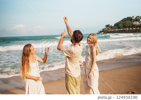 Group of Friends Sharing Joyful Moments on a Beautiful Beach Group of Friends Sharing Joyful Moments on a Beautiful Beach 124938190