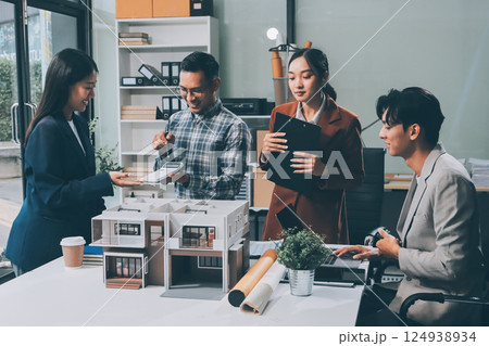 Construction, planning and architects meeting about design of building, strategy and working in industrial collaboration. Architecture workers talking about maintenance project with paper and a model 124938934