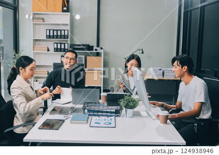 Cheerful meeting room, businesspeople celebrate with handshaking. Successful project was completed before the deadline. Business partnership and collaboration in project management. Habiliment 124938946
