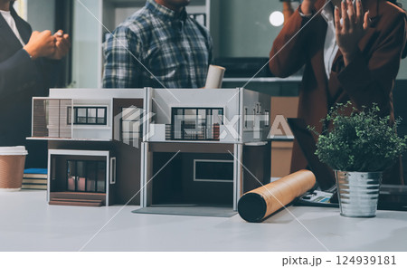 Construction, planning and architects meeting about design of building, strategy and working in industrial collaboration. Architecture workers talking about maintenance project with paper and a model 124939181