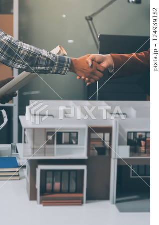 Construction, planning and architects meeting about design of building, strategy and working in industrial collaboration. Architecture workers talking about maintenance project with paper and a model Construction, planning and architects meeting about design of building, strategy and working in industrial collaboration. Architecture workers talking about maintenance project with paper and a model 124939182