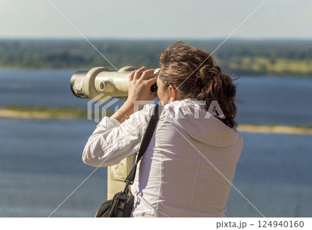 Tourist looking through a telescope Tourist looking through a telescope 124940160