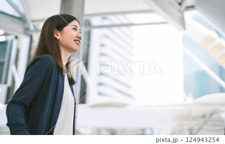 Portrait of successful business asian woman standing looking forward at outdoors in city Portrait of successful business asian woman standing looking forward at outdoors in city 124943254