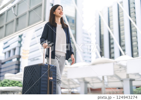 Adult business asian woman walking with luggage for work and travel at station platform on day Adult business asian woman walking with luggage for work and travel at station platform on day 124943274