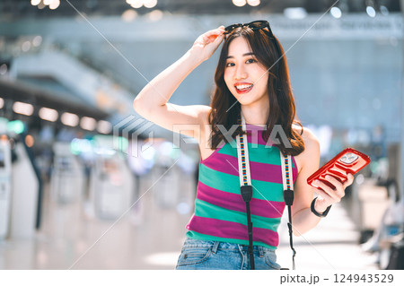 Portrait of tourist woman eye looking camera with happy smile face at airport terminal 124943529