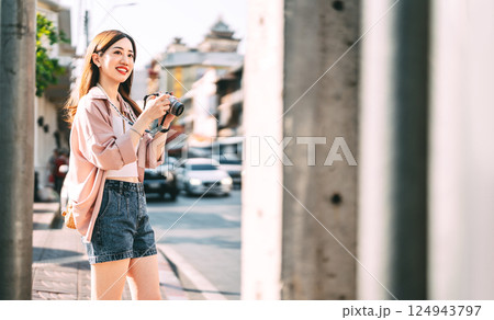Happy adult asian woman traveler using digital camera travel in southeast asia at outdoors on day Happy adult asian woman traveler using digital camera travel in southeast asia at outdoors on day 124943797