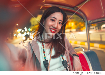 Adult asian woman solo travel enjoy night trip selfie on tuk tuk local taxi Bangkok city Adult asian woman solo travel enjoy night trip selfie on tuk tuk local taxi Bangkok city 124943805
