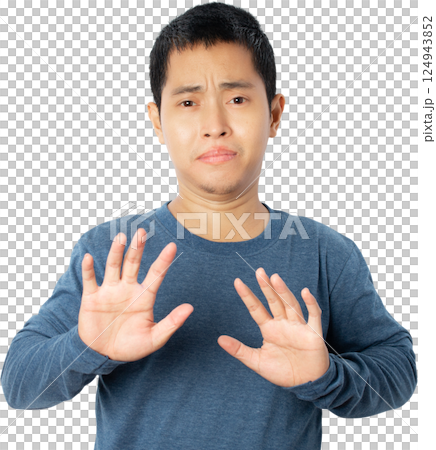 Asian young man showing stop gesture. Asian young man showing stop gesture. 124943852