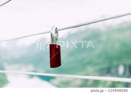 Red padlock and Geirangerfjord from Flydasjuvet viewpoint Norway Red padlock and Geirangerfjord from Flydasjuvet viewpoint Norway 124948098