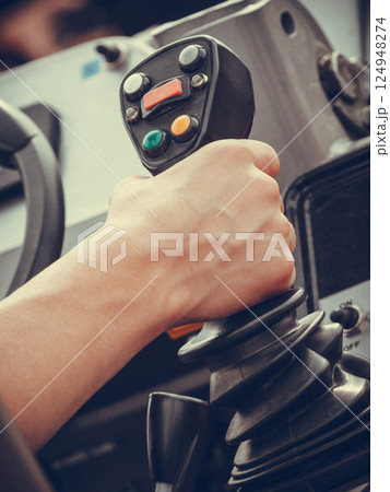 Man operating big industrial agricultural machine Man operating big industrial agricultural machine 124948274