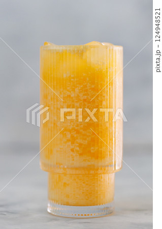 Orange Dirty Soda in Tall Glass on Gray Background, Trendy Carbonated Drink, Close-Up 124948521