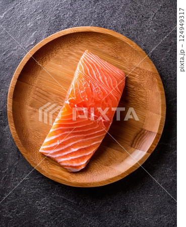 raw salmon one pieces on the wooden plate raw salmon one pieces on the wooden plate 124949317