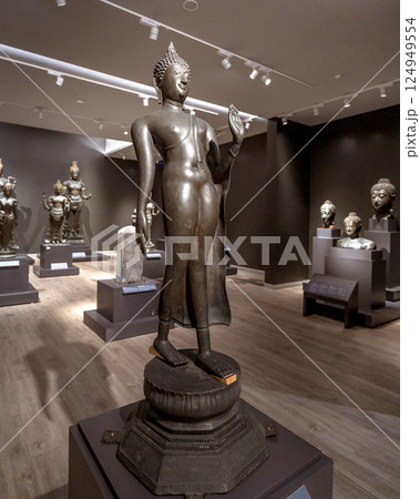 Elegant bronze standing Buddha statue at National Museum Bangkok, representing Sukhothai era art and spiritual heritage of Thailand. Elegant bronze standing Buddha statue at National Museum Bangkok, representing Sukhothai era art and spiritual heritage of Thailand. 124949554