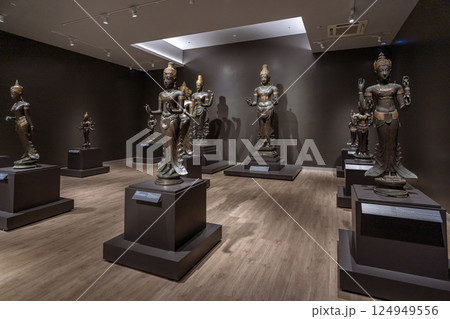 Bronze Hindu deities and a stone inscription at the National Museum Bangkok highlight ancient Southeast Asian religious art and cultural heritage. 124949556