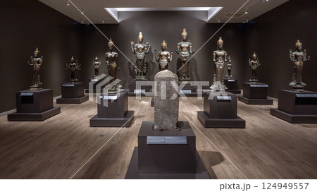 Bronze Hindu deities and a stone inscription at the National Museum Bangkok highlight ancient Southeast Asian religious art and cultural heritage. 124949557