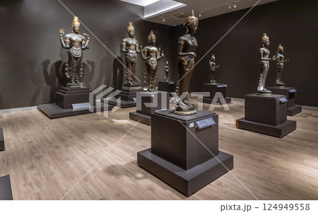 Bronze Hindu deities and a stone inscription at the National Museum Bangkok highlight ancient Southeast Asian religious art and cultural heritage. 124949558