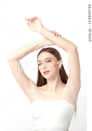 Beautiful Young woman Raises her hands to Showcase clean and hygienic underarms Against a white background, Smooth armpit cleanliness and protection concept Beautiful Young woman Raises her hands to Showcase clean and hygienic underarms Against a white background, Smooth armpit cleanliness and protection concept 124949749