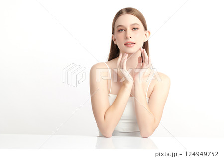 A beautiful young Asian woman with clean, fresh skin against a white background. Skincare, facial treatment, cosmetology, beauty, and spa. An elegant portrait of an Asian woman. 124949752