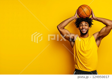 A man holding a basketball over his head A man holding a basketball over his head 124950017