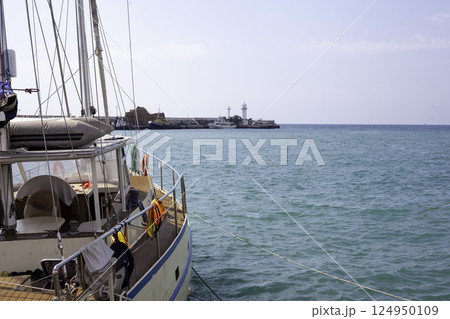 Boat yacht on the pier. Sea pier and lighthouse Yalta 124950109