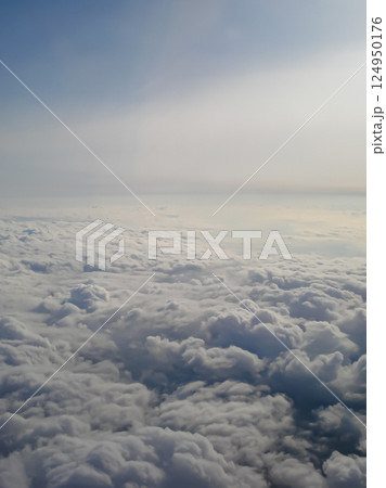 Clouds view from the airplane window. The sky is with cumulus clouds. Beautiful background. Travels. Flying over the cloud. To fly Clouds view from the airplane window. The sky is with cumulus clouds. Beautiful background. Travels. Flying over the cloud. To fly 124950176
