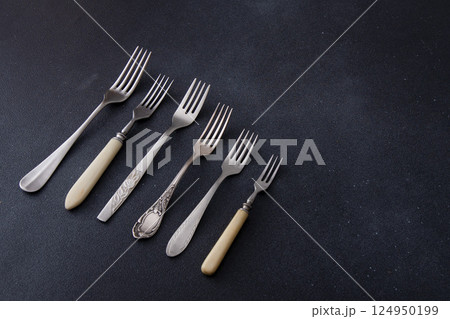 Forks on a black background. Set of old different cutlery for food. Forks on a black background. Set of old different cutlery for food. 124950199