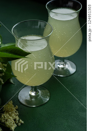 Carbonated elderflower drink. Flower summer kvass in glasses Carbonated elderflower drink. Flower summer kvass in glasses 124951303