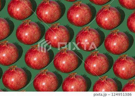Pomegranate pattern. Red pomegranates on a green background. Fruit food. 124951386