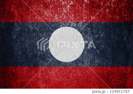 Banner of the grunge Laos state flag. Dirty Laos flag on a metal surface. Banner of the grunge Laos state flag. Dirty Laos flag on a metal surface. 124951787