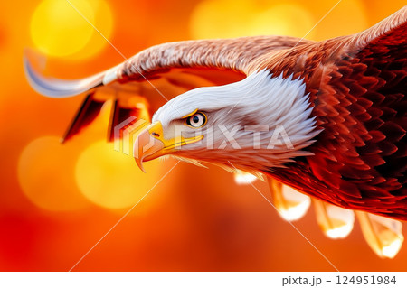 A bald eagle flying through the air with its wings spread 124951984