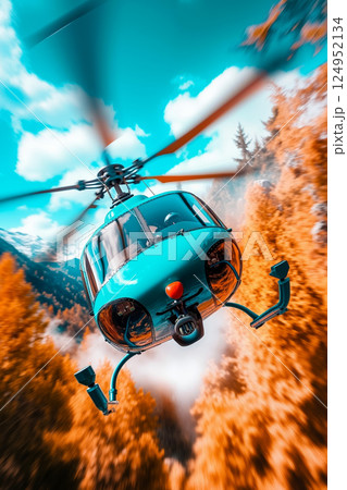 A blue helicopter flying through the air over a forest 124952134