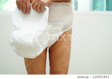 Asian senior woman patient wearing adult incontinence diaper pad in hospital. 124952851