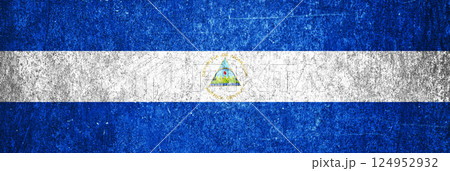 Nicaragua state flag on a metal surface. Banner of dirty grunge Nicaragua flag. 124952932
