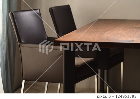 Minimalist kitchen interior with walnut dining table and leather arm chairs Minimalist kitchen interior with walnut dining table and leather arm chairs 124953595