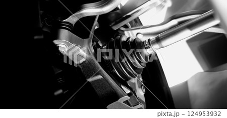 Car suspensions. Close up of a car suspension parts system such as CV joint Rubber boot and Control arms bushing Steering rack axles Shock absorber suspension Brake. Repair and spare parts for cars. 124953932