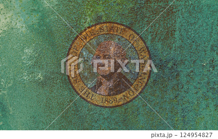 Washington State Flag. Dirty Washington state flag on rusty metal surface. 124954827