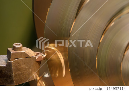 Close up scene the lathe machine finish cut the brass material. Close up scene the lathe machine finish cut the brass material. 124957114