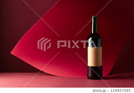 Bottle of red wine on a red background. Bottle of red wine on a red background. 124957265