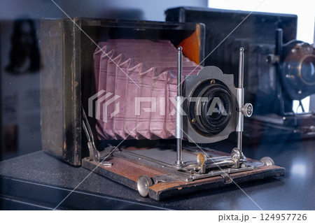 Old wooden photo camera and lens Old wooden photo camera and lens 124957726