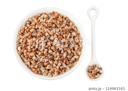 Boiled buckwheat in a ceramic bowl isolated on white background. Top view. Flat lay 124963163