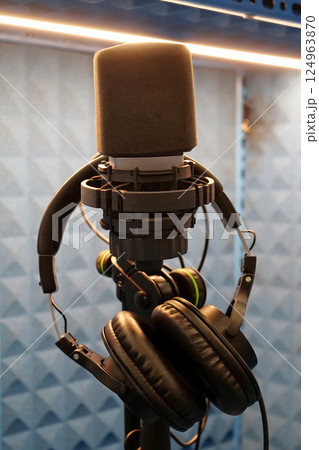 Microphone and headphones in a recording studio 124963870