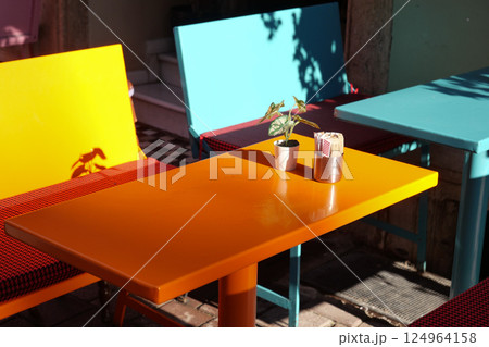 A Vibrant and Lively Outdoor Cafe Scene Filled with Colorful Furniture A Vibrant and Lively Outdoor Cafe Scene Filled with Colorful Furniture 124964158