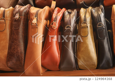 Close up of leather handmade bags on a wall for sale Close up of leather handmade bags on a wall for sale 124964168