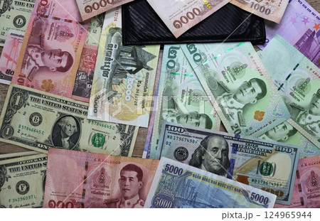 Banknotes of different countries and colors on the table Banknotes of different countries and colors on the table 124965944