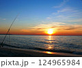 Fishing from the sandy beach, spinning rods and fishing rods stand on the shore 124965984