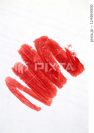 Close-up of a red lipstick smear on a white background Close-up of a red lipstick smear on a white background 124969800