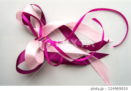 Pink and purple ribbon isolated on a white background, the concept of decorating gifts and postcards Pink and purple ribbon isolated on a white background, the concept of decorating gifts and postcards 124969810